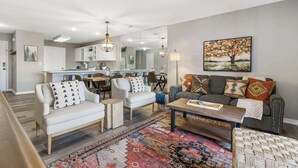 A modern living room with a sofa, coffee table, and patterned rug. - Pointe Royale Retreat | Relaxation Awaits! (Branson)