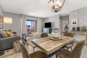 Relax in this cozy living space with a sofa, armchairs, and dining table.