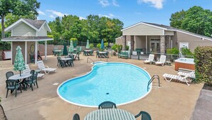A pool area with lounge chairs, tables, and umbrellas. - Boatin & Floatin on Table Rock Lake in the Ozarks! (Kimberling City)