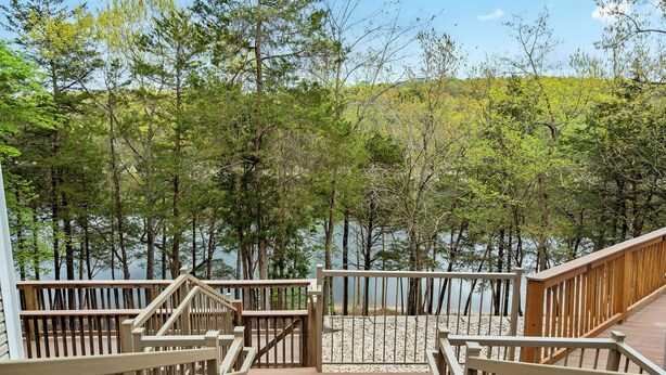 A wooden deck leading to a lake surrounded by trees. - Boatin & Floatin on Table Rock Lake in the Ozarks! (Kimberling City)