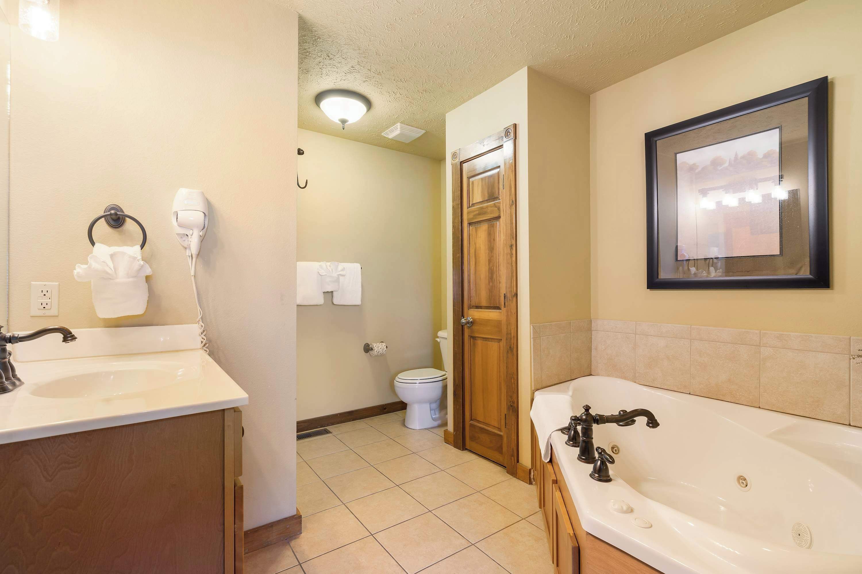 A bathroom with a sink, toilet, and bathtub.