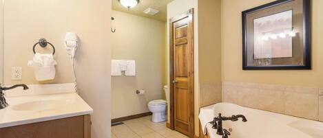 A bathroom with a sink, toilet, and bathtub.