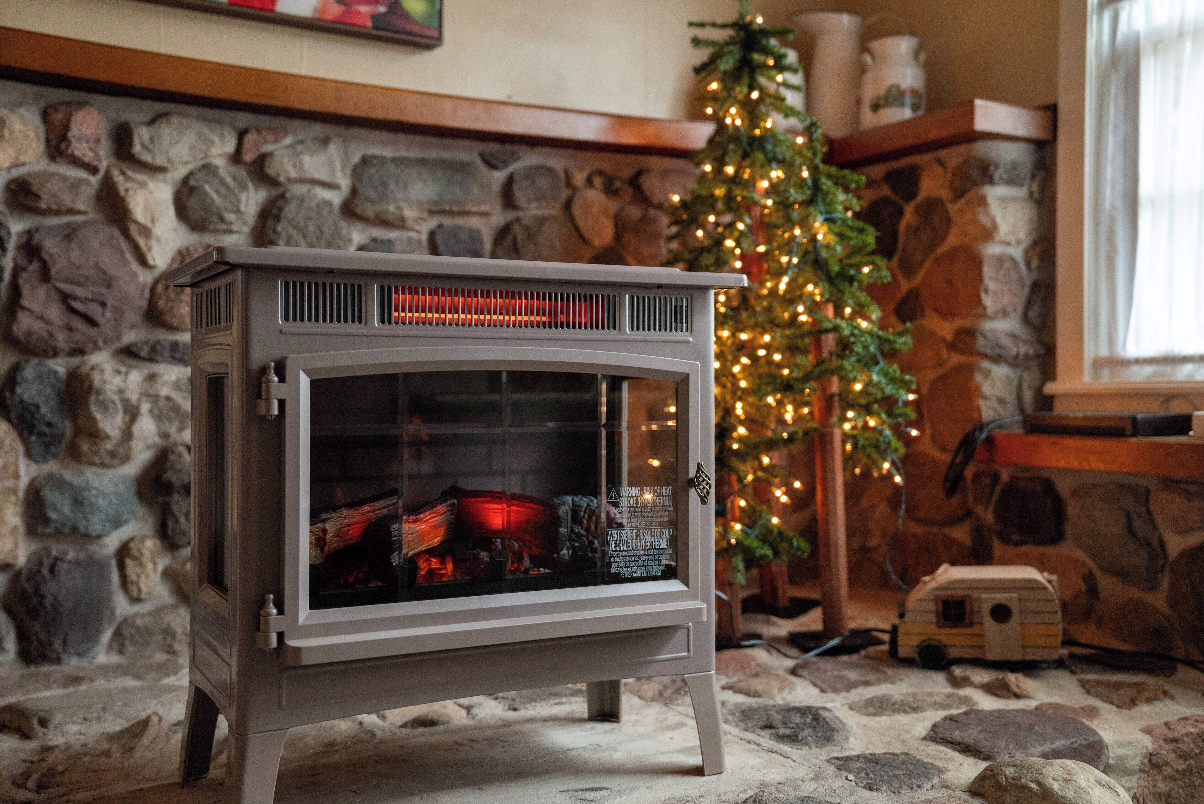 A stone fireplace with a white wood-burning stove in front.