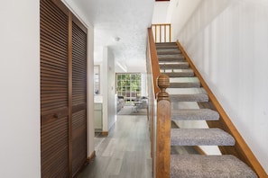 Stairs lead to a cozy upper level with a comfortable living area below.