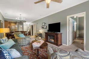 Cozy and spacious living area with TV and fireplace