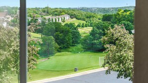 A view of a golf course with a clubhouse and surrounding greenery. - Glorious Relaxation| Golf Course Views (Branson)