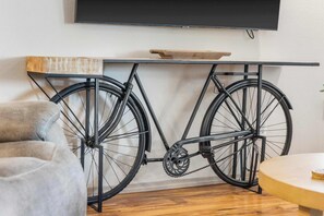 A bicycle mounted on a wall-mounted rack with a wooden shelf above it. - Glorious Relaxation| Golf Course Views (Branson)