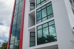 Stylish building with a modern facade and large windows offering expansive views of the surrounding greenery.