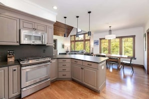 Enjoy cooking in this well-lit kitchen with a stainless steel range and large island with seating.