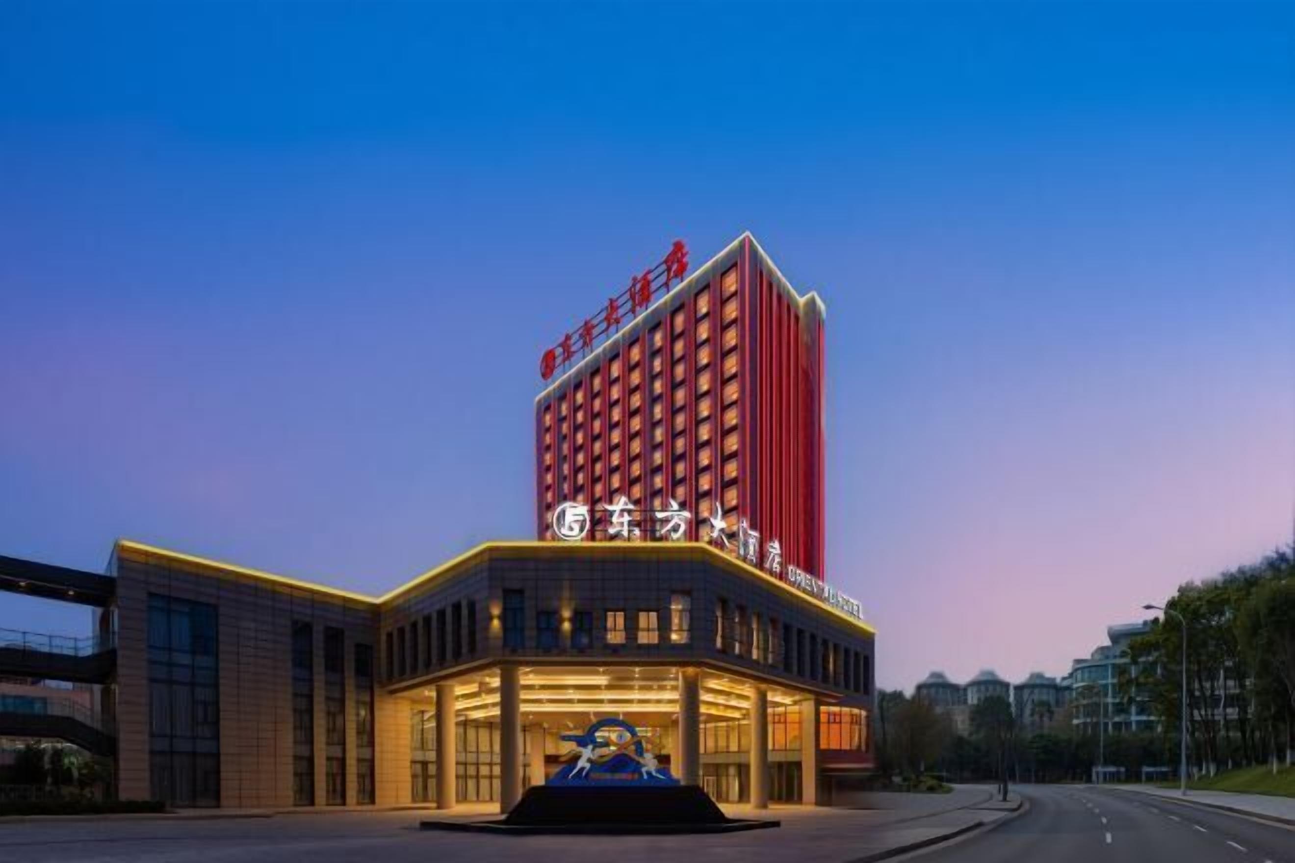 A hotel with a prominent red building and a modern entrance.
