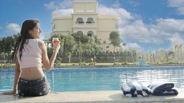 A poolside view with a building in the background.
