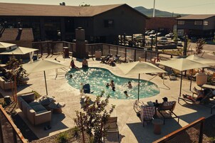 Una piscina al aire libre de temporada, sombrillas