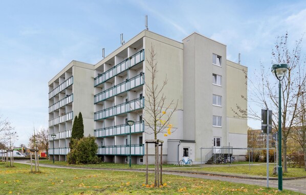 Stylish residential building with a symmetrical facade and balconies.