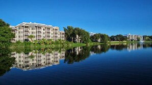 A large hotel with multiple floors and a reflection in the water. - Fantastic condo in Orlando; fully equipped kitchen, washer/dryer, WiFi (Orlando)