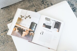 An open book with a page displaying a modern interior design, a section titled 'Vanessa Alexander' with a brief description, and a small image of a room with a wooden table and chairs. - New! Modern 4BR walk to Reno-Sparks Conv Center, Atlantis Casino & shops (Reno)