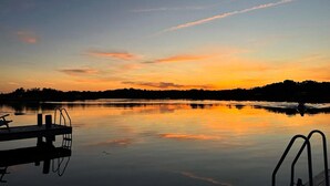 A calm lake at sunset with a dock and metal railings. - Nice home in Ronneby with WiFi (Ronneby)