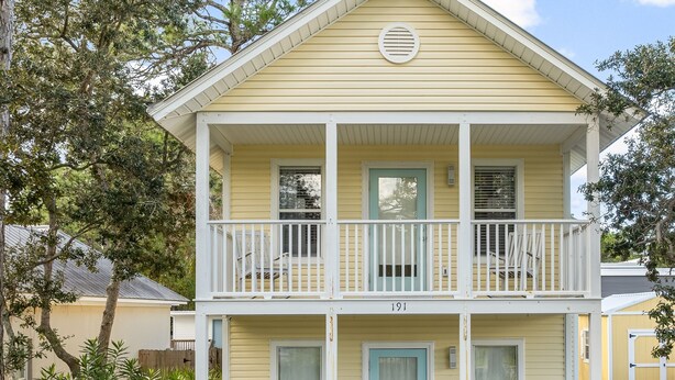 A two-story building with a light yellow exterior, a balcony on each floor, and a blue door. - 2 Bikes~ Newly renovated Pool~Bike to Seaside (Santa Rosa Beach)