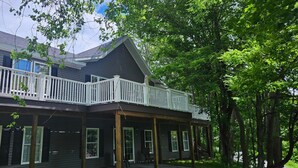 A two-story house with a balcony and a covered porch. - The Monarch - Private Setting, Heated Pool,  6 Bedroom, New Build. 6 min to CDP (Fly Creek)