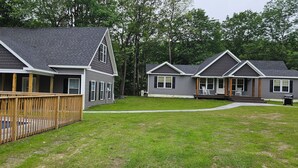 A row of two-story houses with a wooden deck in front of the first house. - The Monarch - Private Setting, Heated Pool,  6 Bedroom, New Build. 6 min to CDP (Fly Creek)