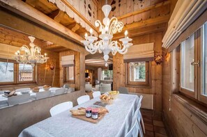 Enjoy meals in this cozy cabin-style dining area with a large dining table and comfortable seating.
