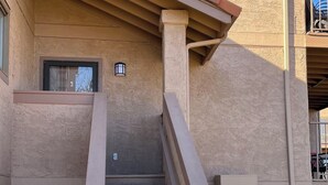 A multi-story building with a staircase leading to the entrance.