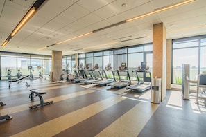 A modern gym with treadmills, stationary bikes, and weight machines. - ROVE LIVING/KB - Joy on 4th (Phoenix)