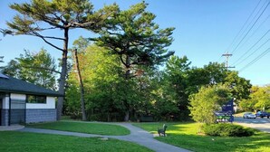 A residential area with a paved walkway, a bench, and a sign for 'Mule Creek Lake'. - Full 4 bedrooms single house at Halifax Peninsula (Halifax)