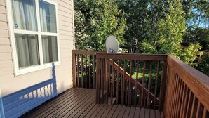 A wooden deck with a railing, a satellite dish, and a house with white siding and a window. - Full 4 bedrooms single house at Halifax Peninsula (Halifax)