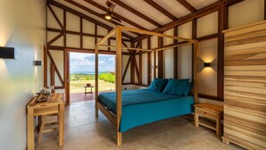 A bedroom with a four-poster bed, wooden walls, and a view of the outdoors. - Ecolodges Puyferrat (Le Marin)