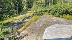 A natural landscape with a wooden deck and a rocky terrain. - 3 bedroom awesome home in Ljusterö (Ljusterö)