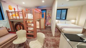 A children's room with bunk beds, a sofa, a chair, a desk with a laptop, and a bed.