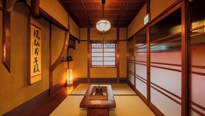 A traditional Japanese room with tatami flooring, sliding doors, and a hanging lantern. -  Nijo-Ouan (Kyoto)