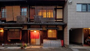 A traditional Japanese building with tatami mat flooring, sliding doors, and a small garden area with potted plants. -  Nijo-Ouan (Kyoto)