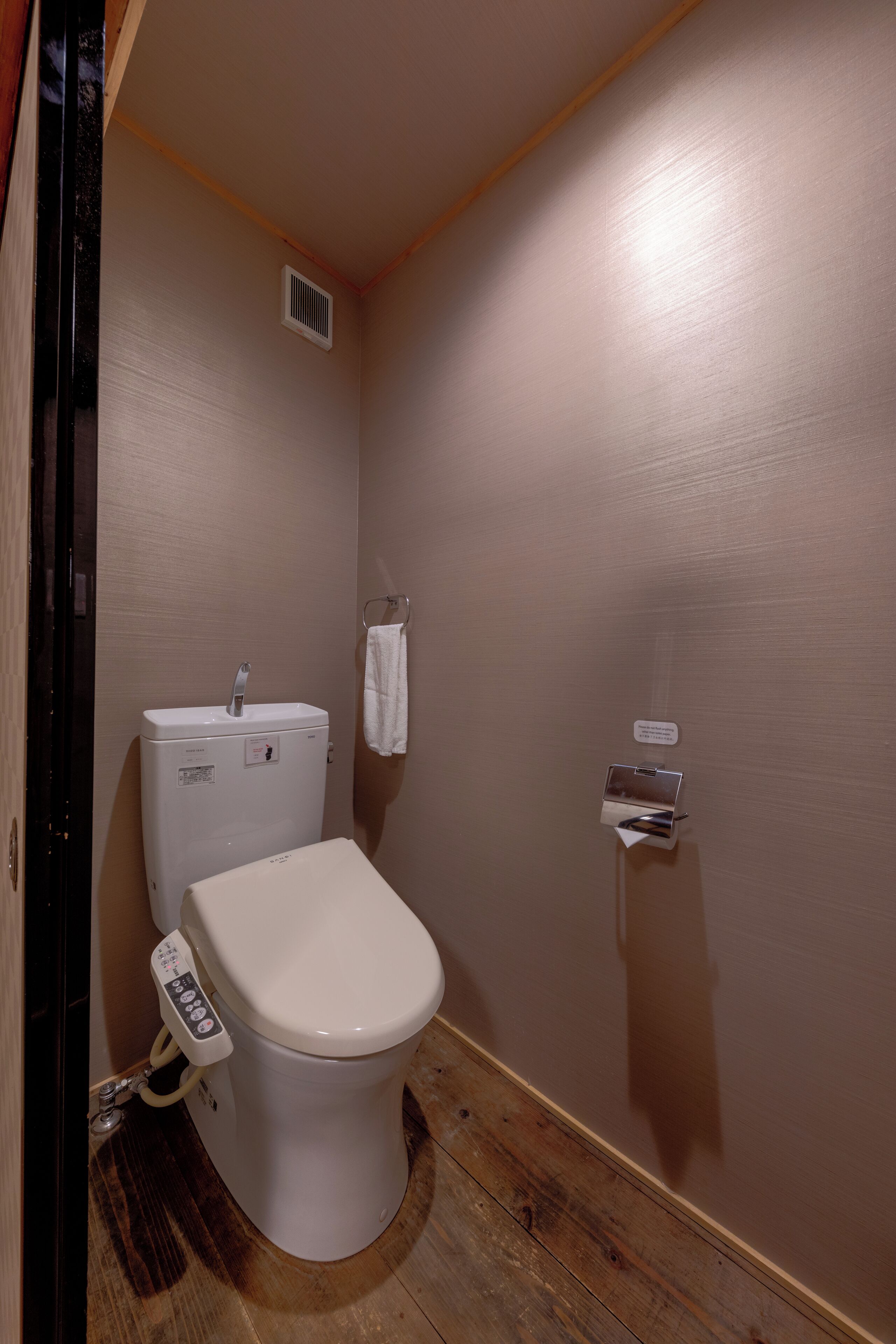 Ein kleines Badezimmer mit Toilette, Waschbecken und Handtuchhalter.