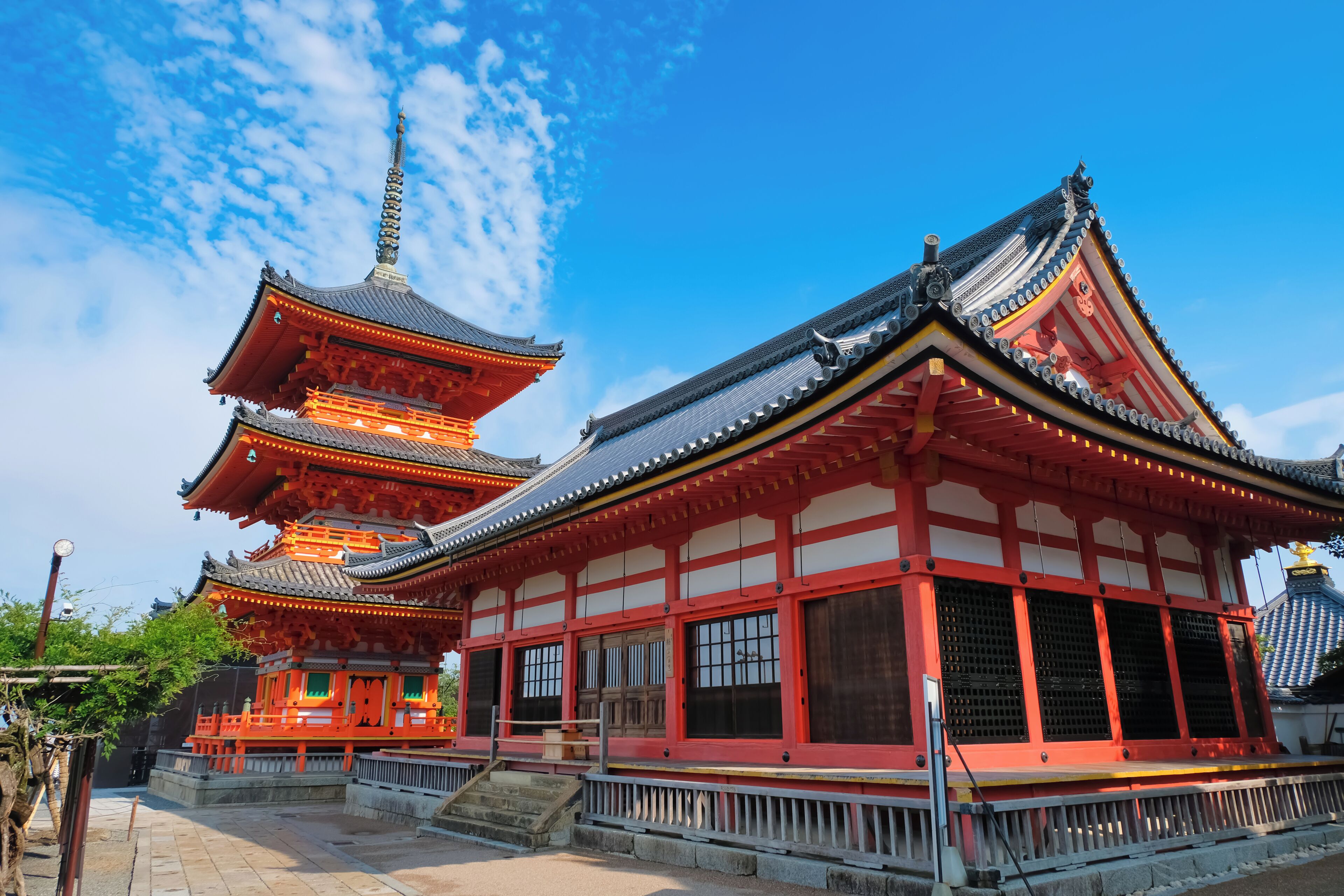 A traditional Japanese temple with multiple pagoda-style roofs and a main hall with red and white walls.