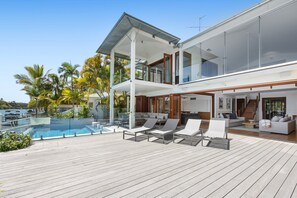 A modern two-story house with a pool, outdoor seating, and a view of the sea. - Riverside Elegance on Noosa Parade (Noosa)