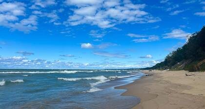 Serene Lake Michigan home with private beach access, wooded land, near town.