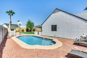A backyard with a swimming pool, a white building, and a palm tree. - Pool, Basketball + BBQ! Glendale Group Getaway (Glendale)