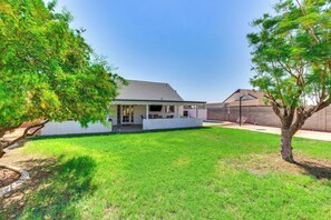 A house with a covered patio, a swimming pool, and a well-maintained lawn. - Pool, Basketball + BBQ! Glendale Group Getaway (Glendale)