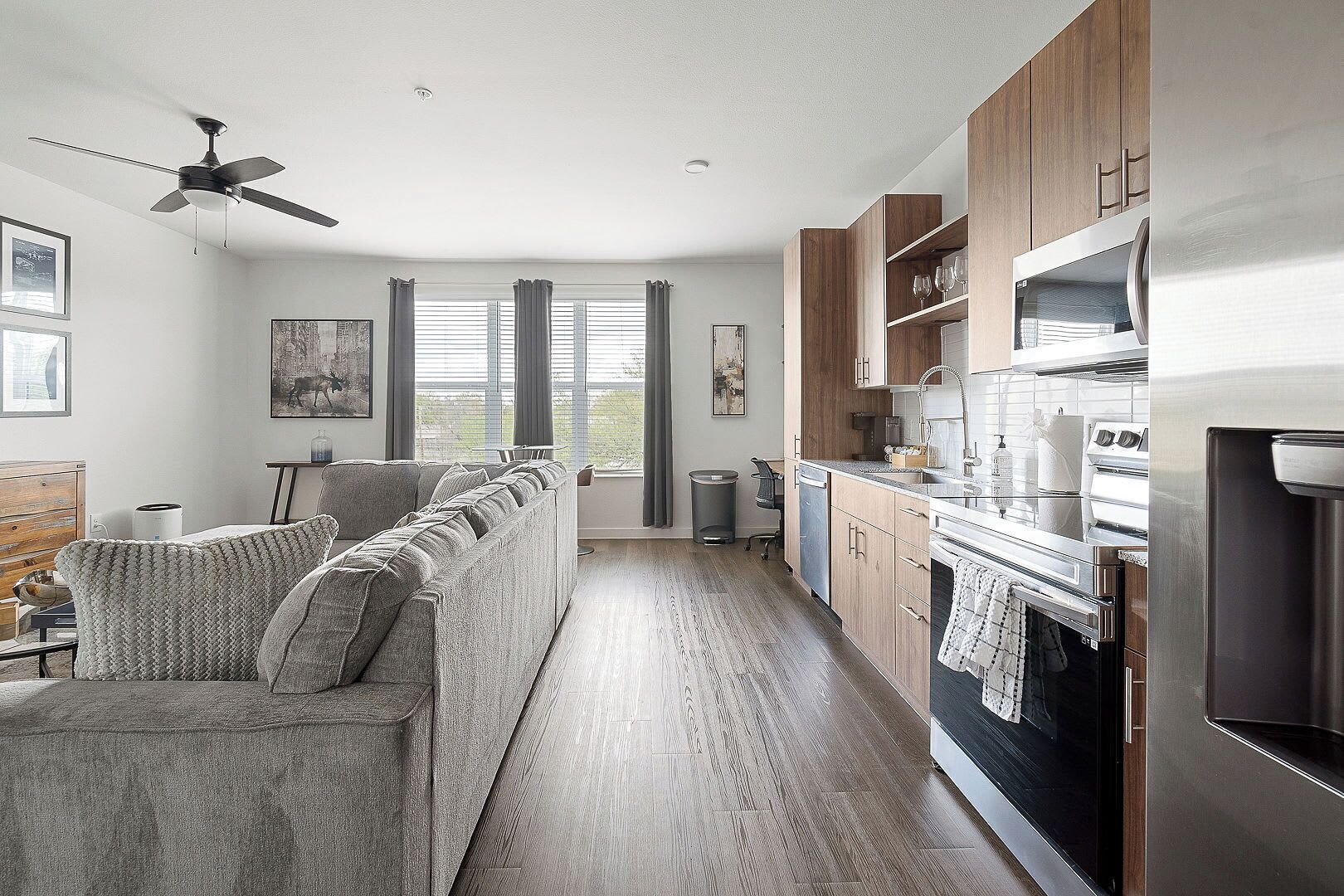 A modern kitchen with wooden cabinets, stainless steel appliances, and a built-in oven.