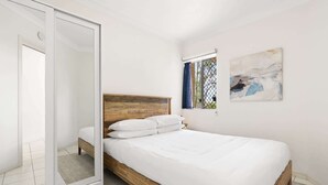 A bedroom with a bed, a window with curtains, a painting, and a sliding door. - Chic 1-Bed Escape with Parking Bridgeman Downs (Bridgeman Downs)