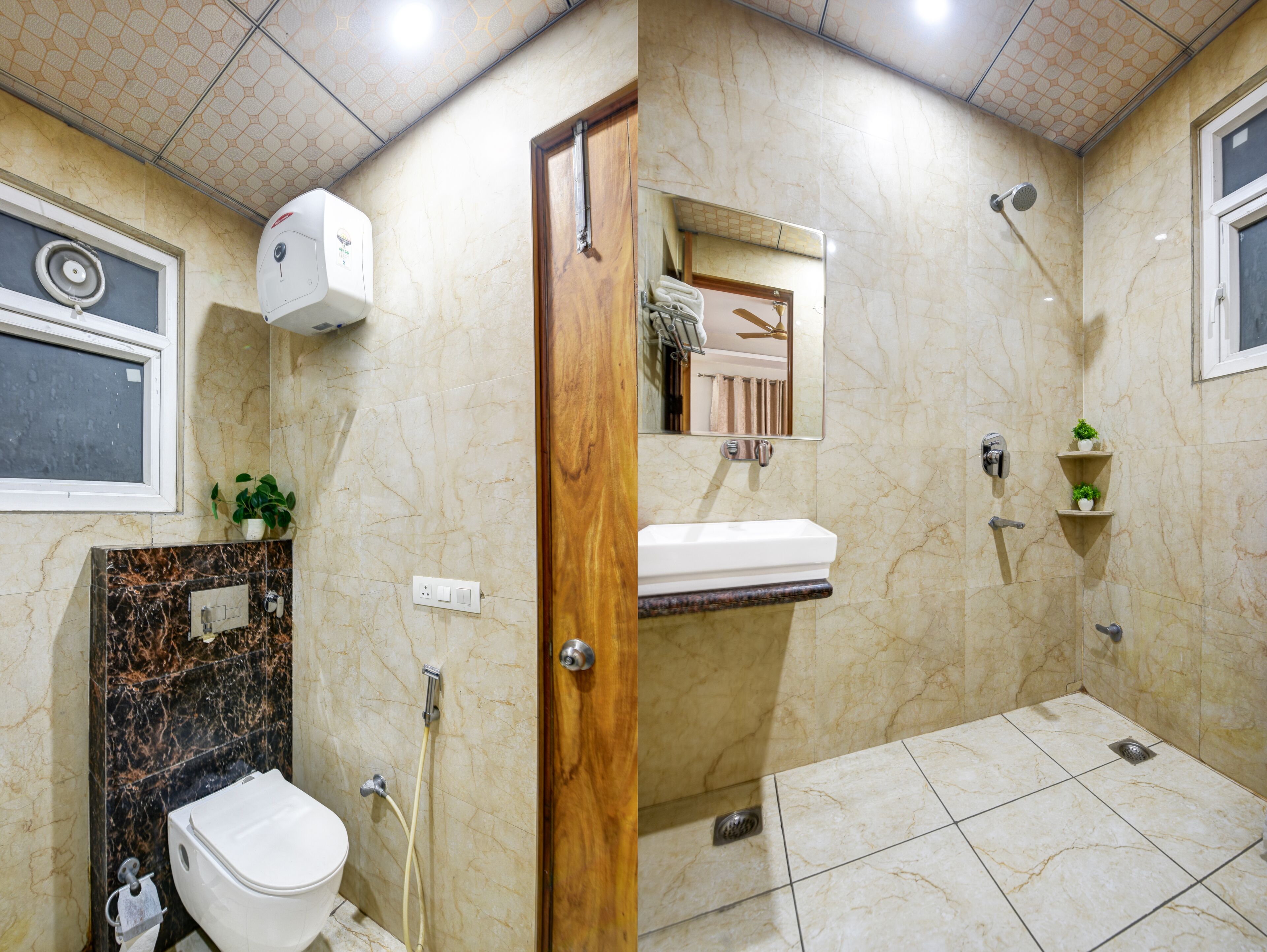 A bathroom with a toilet, sink, shower, and a mirror.