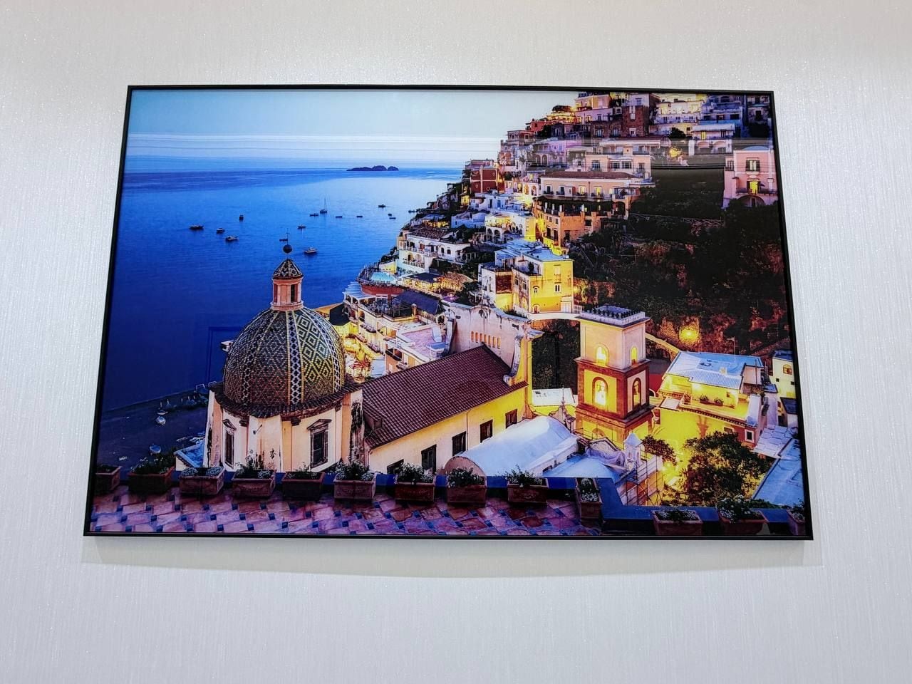 A coastal town with a prominent church and buildings along the waterfront.