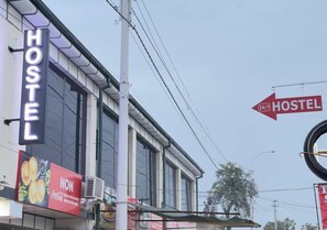 A hostel with a prominent 'HOSTEL' sign and a Coca-Cola advertisement. - Parvona Hostel (Tashkent)