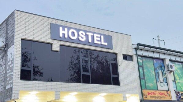 A building with a sign that reads "HOSTEL" on the facade. - Parvona Hostel (Tashkent)