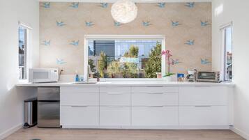 Fridge, microwave, coffee/tea maker, cookware/dishes/utensils