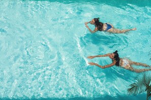An aerial view of a swimming pool with two individuals swimming. - Lum Residence (Ahangama)
