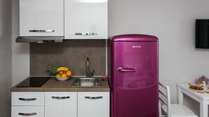 A modern kitchen with white cabinets, a stainless steel sink, and a purple refrigerator. - Villa Mirjana - Standard Studio Apartment with Terrace and Sea View (Lavanda) (Mlini)