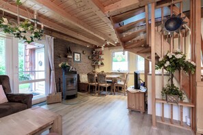 Cozy seating area with a sofa and dining space, featuring a staircase leading to an upper level.