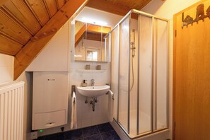 Ein Badezimmer mit Dusche, Waschbecken und Toilette.